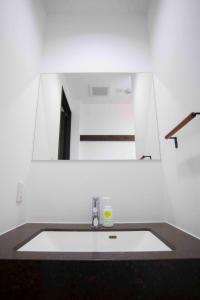 a bathroom with a sink and a mirror at Shinjuku Miyabi Residence - Vacation STAY 94836 in Tokyo