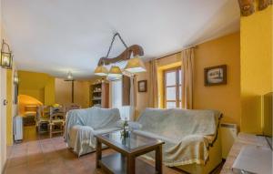 a living room with two chairs and a table at Cozy Home In La Cardenchosa With Wifi in El Alcornocal