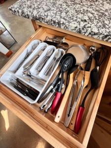 a drawer filled with utensils on a table at Brightstone Lake Cabin 1 in Fair Oaks
