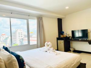 a hotel room with a swan decoration on a bed at U Hatyai Hotel in Hat Yai