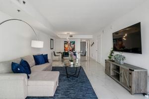 a living room with a couch and a tv at Awesome Penthouse Apt Brickell W/Pool in Miami