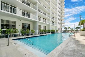 a swimming pool in front of a building at Awesome Penthouse Apt Brickell W/Pool in Miami
