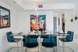 a dining room with a glass table and chairs at Awesome Penthouse Apt Brickell W/Pool in Miami