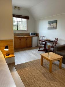 a living room with a couch and a table at Sienna Lodge in Yallingup