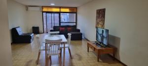 a living room with a couch and a table with a tv at Departamento Mendoza in Mendoza