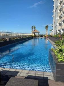 a large swimming pool in front of a building at Coast Residence Pasay in Manila