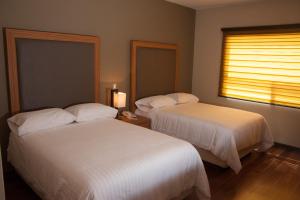 A bed or beds in a room at MBM Red Sun Hotel