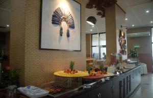 a buffet line in a restaurant with food on it at Flat Hotel Tropical Executive Praia Ponta Negra in Manaus