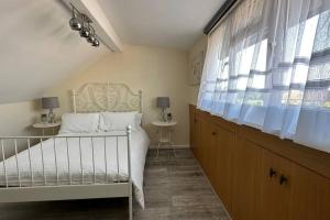 a bedroom with a white bed and a window at Palaz 7 - 5 bedroom house in Edmonton +24 photos