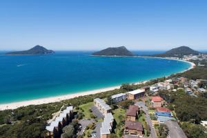 an aerial view of a beach with houses and the ocean at Shoal Bay Shores, modern beachfront unit + Wifi in Nelson Bay