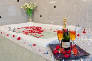 a bath tub filled with confetti next to two champagne glasses at Holiday Inn Express Woodstock-Shenandoah Valley, an IHG Hotel in Woodstock