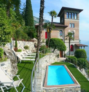 an estate with a swimming pool in front of a house at Villa Monti in Varenna