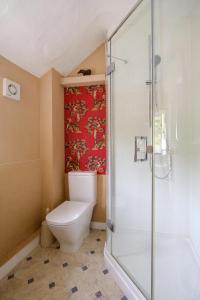 a bathroom with a toilet and a shower at 5 Mariners View in Friston