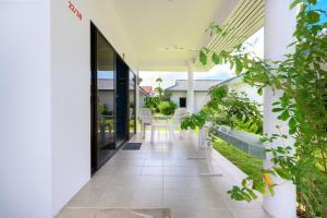 an internal courtyard of a house with plants at Sansuko Ville Panwa in Ban Bo Rae +89 photos