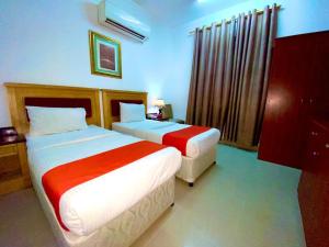 Ένα ή περισσότερα κρεβάτια σε δωμάτιο στο Savoy Inn Hotel Apartments