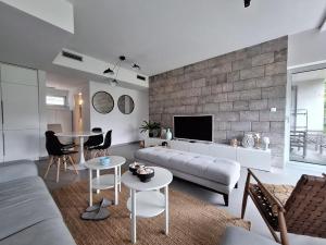 a living room with a couch and a table at Aksioma Kotor in Kotor