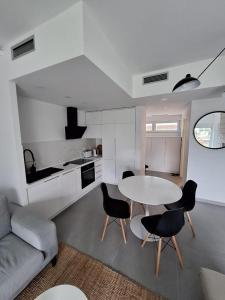 a living room with a table and chairs and a kitchen at Aksioma Kotor in Kotor