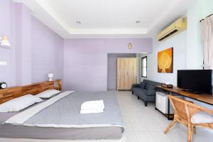 a bedroom with a large bed and a couch at Sunsuko Village Panwa in Ban Bo Rae +88 photos