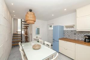 a kitchen with a white table and a blue refrigerator at ORKA 5 in Promajna