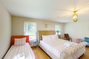 a bedroom with two beds and a chandelier at Music City Sanctuary in Nashville