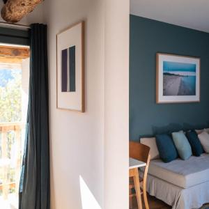 a living room with a couch and a table at Maison Cimes in Les Orres