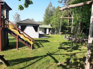 a playground with a slide and a building at Pas danielius in Ramučiai
