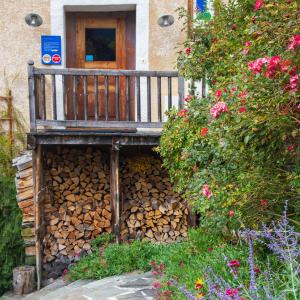a pile of fire wood in front of a house at Maison Cimes in Les Orres