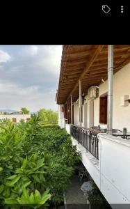 a porch of a house with plants on it at Studios Maro in Skala Kallonis