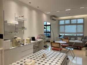 a kitchen with a counter and a table and chairs at 金門且停民宿 可包棟 好停車 近市區 in Jinning