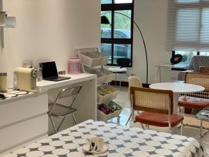 a kitchen with a table and a laptop on a counter at 金門且停民宿 可包棟 好停車 近市區 in Jinning