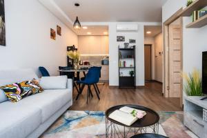 a living room with a couch and a table at Lazdyneliu Vingis in Vilnius