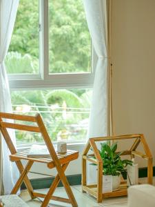 a table and a chair in front of a window at The Giftown Vientiane, Haysoke in Ban Nongdouang