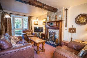 a living room with a couch and a fireplace at Lower Mill 2 Cottage Broadway in Broadway