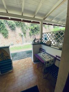 een afgeschermde veranda met een tafel en stoelen erop bij Casa Stella Marina in Anzio