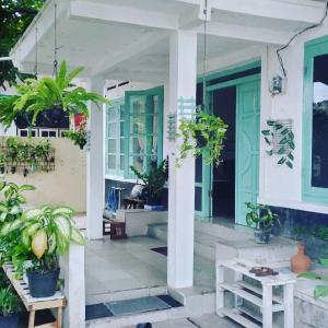 a porch of a house with potted plants at Garser in Yogyakarta