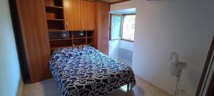 a bedroom with a bed in a room with a phone at Maison de village in Sisco