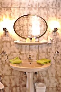 a bathroom with a sink and a mirror at Hotel-Restaurant Im Heisterholz in Hemmelzen +103 photos