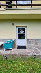 a door to a house with a boat in it at Tatry Ela Big apartment in Vysoké Tatry