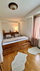 a bedroom with a wooden bed with a window at Tatry Ela Big apartment in Vysoké Tatry