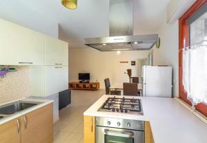 a kitchen with a stove top oven in a room at Miramare casa vacanze in Rimini