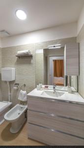 a bathroom with a tub and a sink and a toilet at Miramare casa vacanze in Rimini