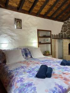 a bedroom with a large bed with blue pillows on it at La Puerta del Sol in Adeje