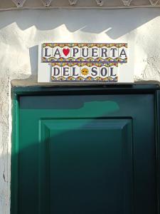 a sign sitting on top of a green refrigerator at La Puerta del Sol in Adeje