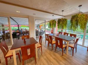 a dining room with tables and chairs and people in a restaurant at Rilena Hotel in Kiten