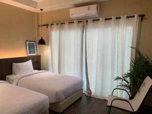 Voodi või voodid majutusasutuse Suncloud Hotel Koh Samet toas