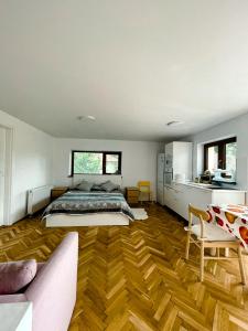 a bedroom with a bed and a wooden floor at Studio minunat de vacanta Cristian in Cristian