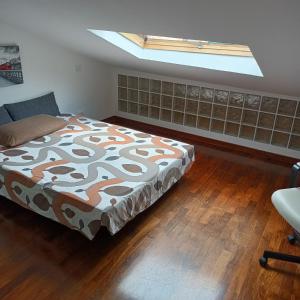 a bedroom with a bed and a skylight at La Mansarda al Borghetto in Nettuno