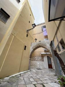 an alleyway in a building with an archway at Borgo degli Svevi rooms in Bari