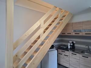 a wooden ladder in a kitchen with a sink at Birs Vendégház Tiszafüred in Tiszafüred