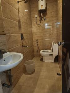 a bathroom with a toilet and a sink at Hotel City Lite Near IGI Airport Delhi in New Delhi